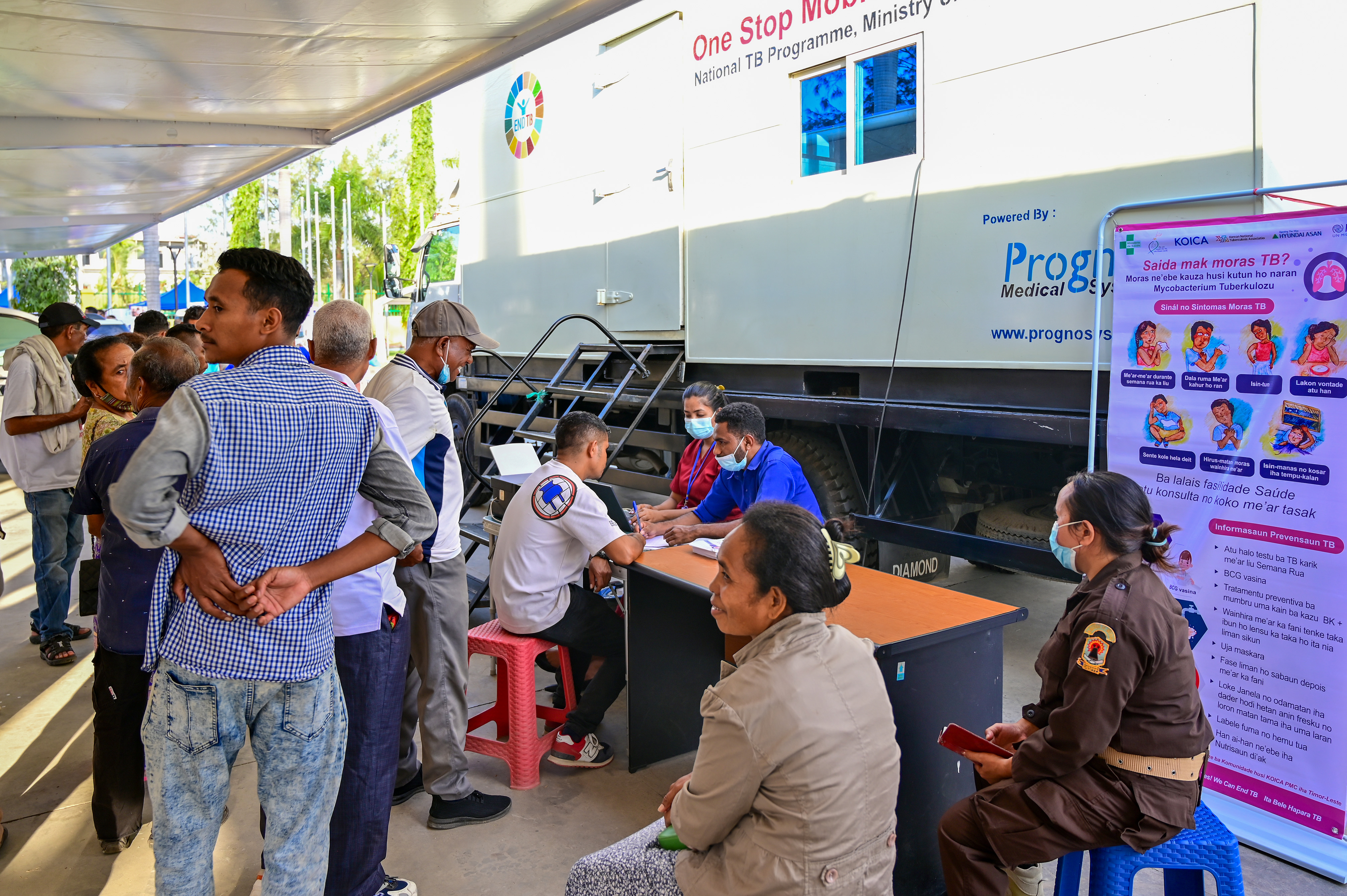 People line up for a test near the mobile TB screening van