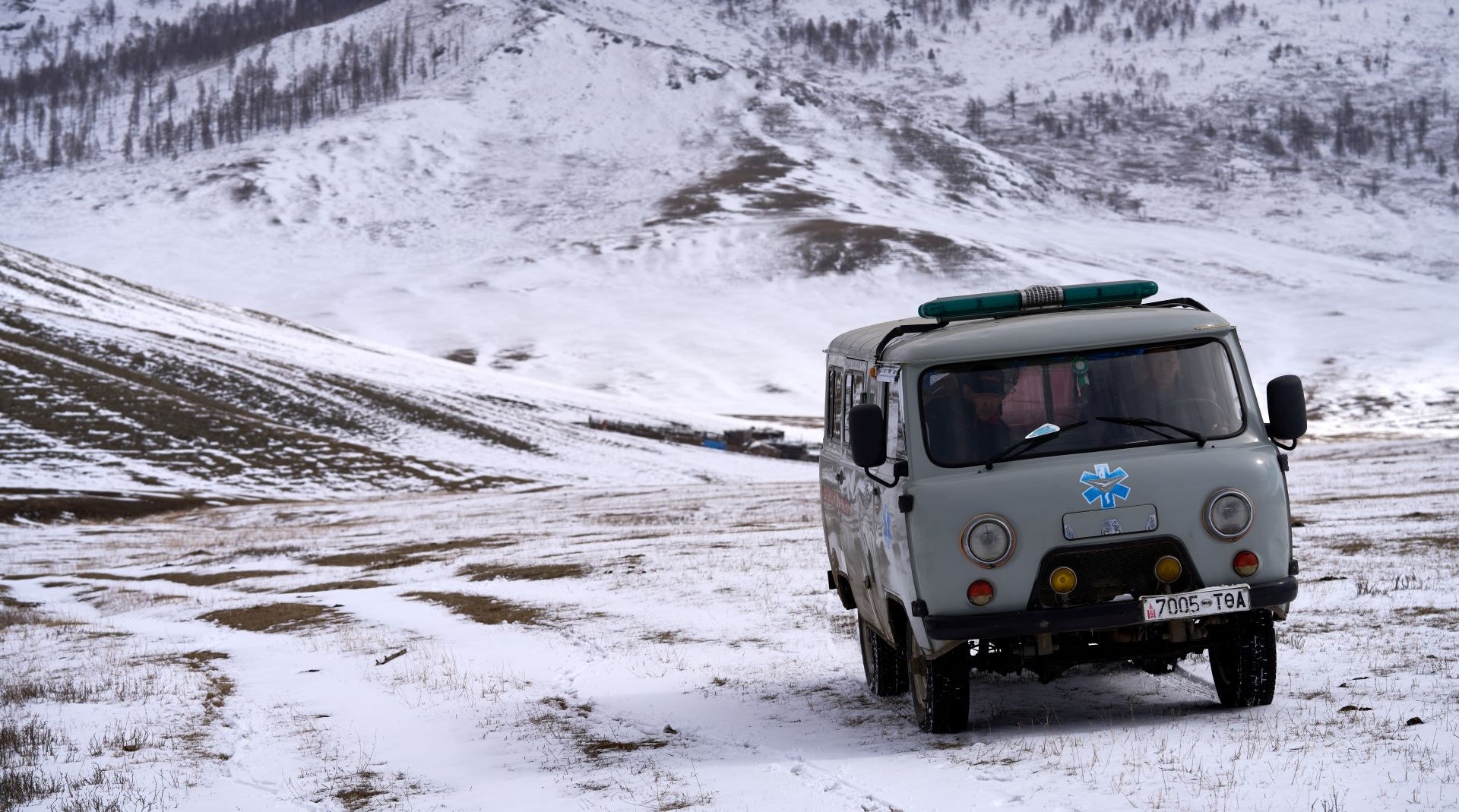 LocalAmbulanceOnTheRoad_Batsumber_Mongolial An ambulance in Mongolia drives through snow